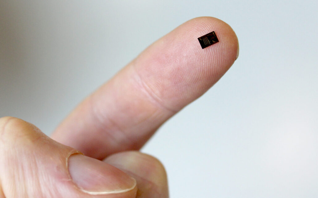 pic on a finger an photonic integrated photonic circuit chip on a fingertip