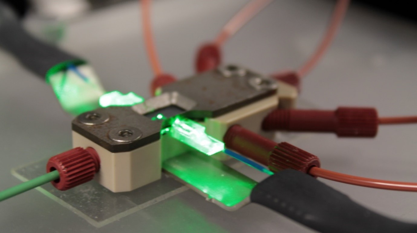 A picture of a custom packaging for a specific opto-fluidic solution for cell flow, illumination, and detection.